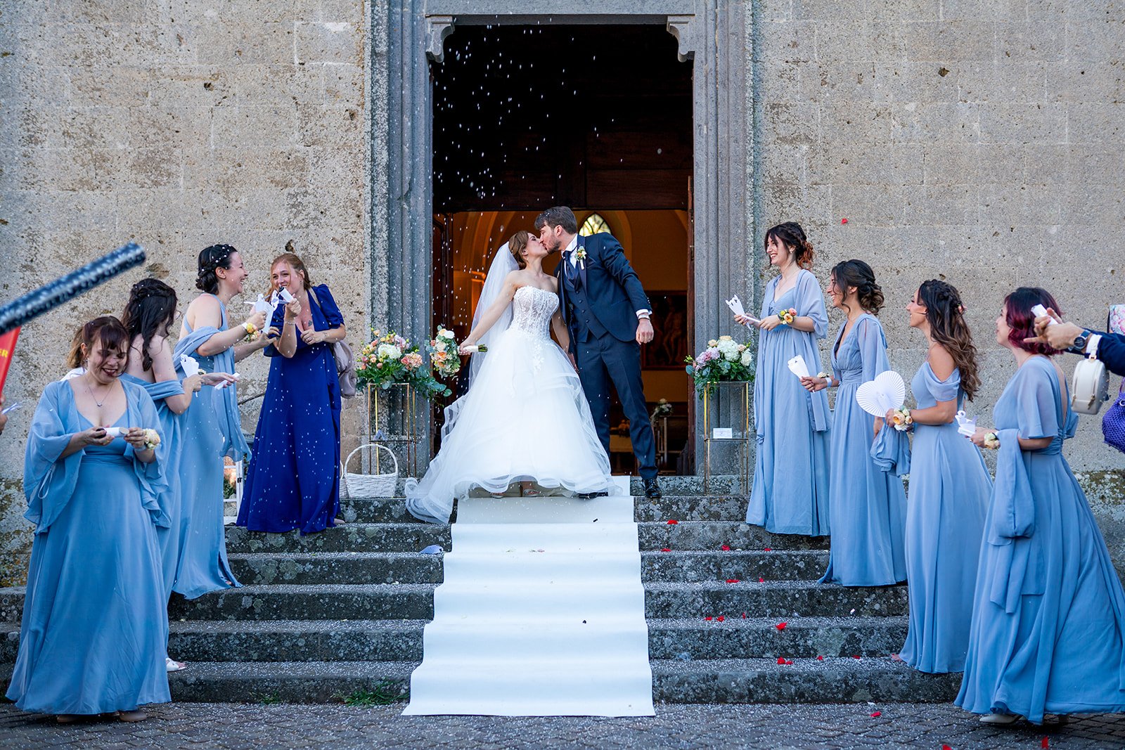 Ceremony under a floral arch at dusk in Tuscany