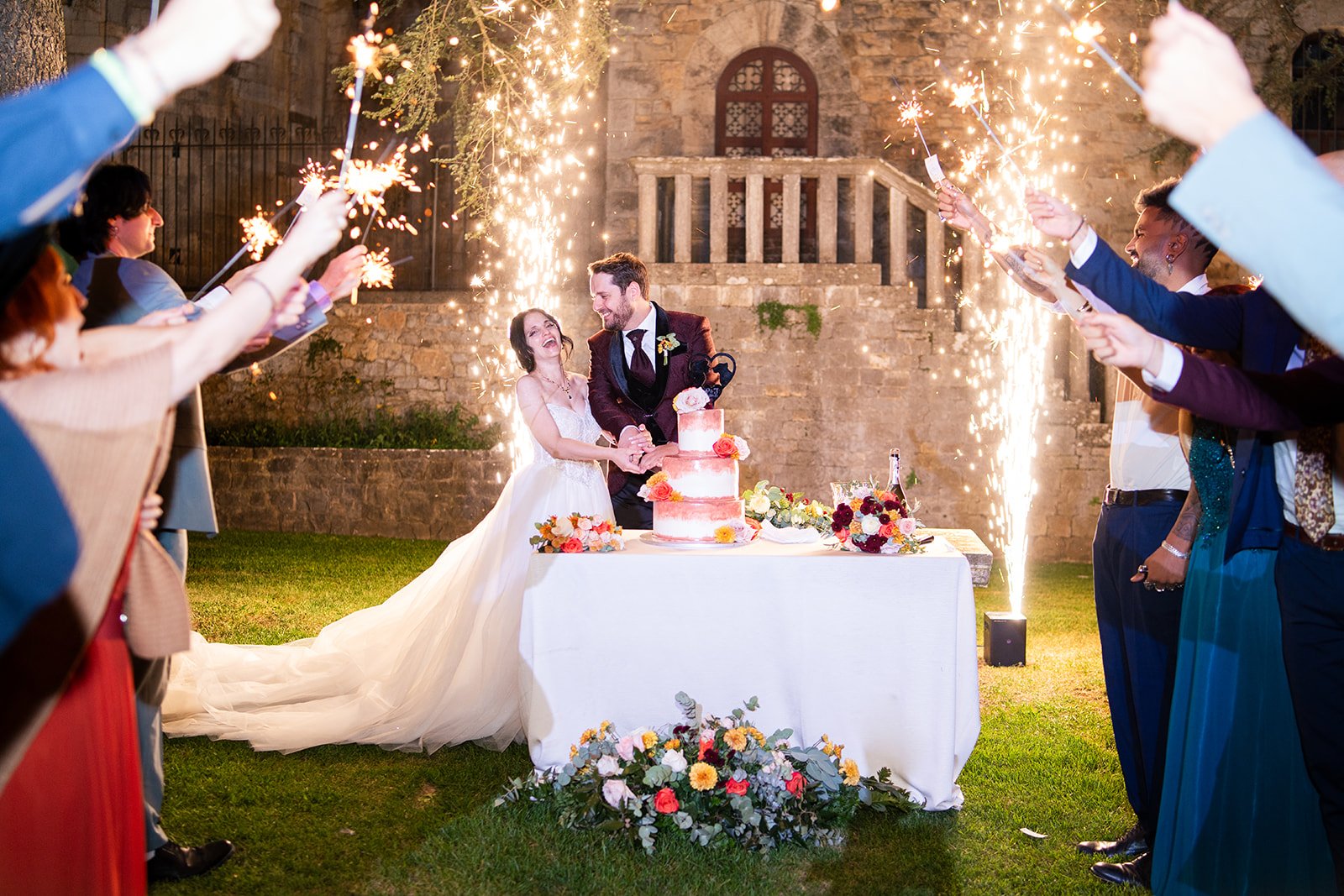 Ceremony under a floral arch at dusk in Tuscany